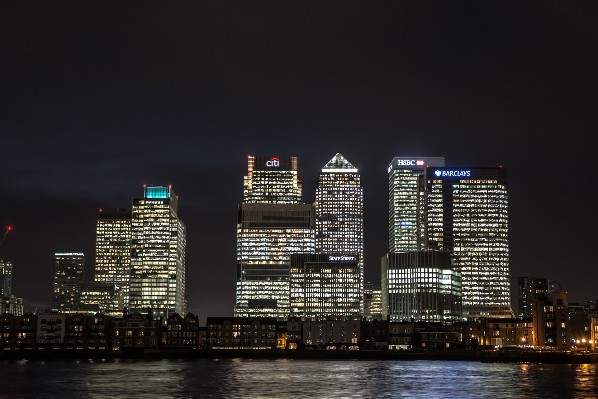 Canary Wharf office buildings illuminated at night, representing business cost visibility and control